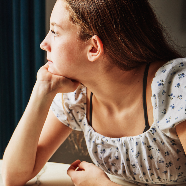 Teen girl wearing Elli Girls Bralette in Gray under a floral top, showing thin straps and smooth coverage