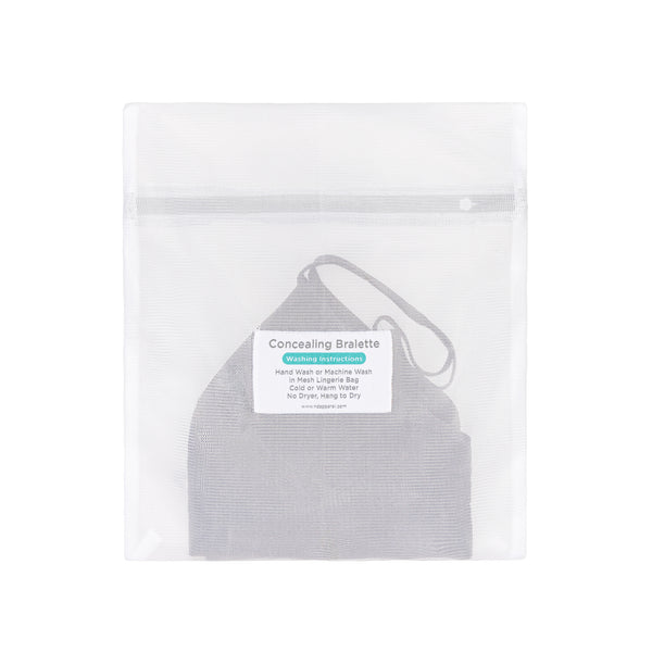 Back view of the Non Disclosure Apparel mesh laundry bag with a bralette inside, showing the printed care and washing instructions label.