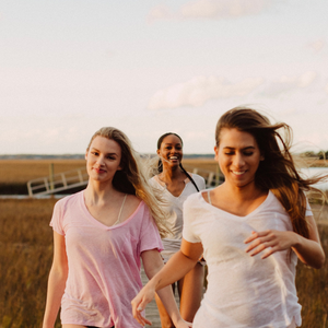 girls walking together down a boardwalk
