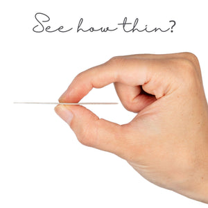 Hand holding a concealing petal with text 'See how thin?' on a white background