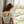 Back view of teen girl wearing Elli Girls Bralette in Gray under a floral crop top, showing adjustable straps