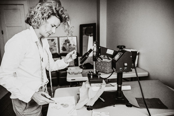 owner becky connelly of non disclosure apparel at her desk