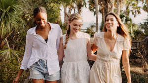 three women walking with their arms around each other in seamless, wireless bralettes